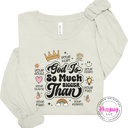 Natural long sleeve tee showing a black God Is So Much Bigger Than faith print.