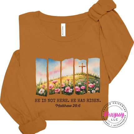 Toast long sleeve tee displaying a He Has Risen cross and wildflowers design.