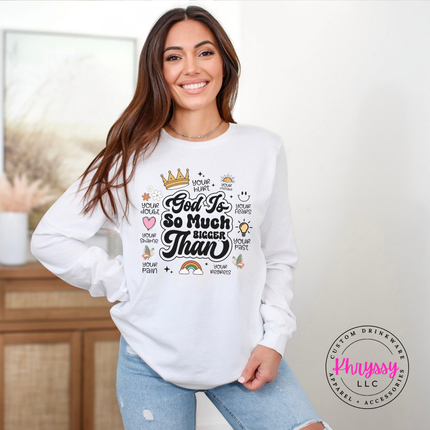 White long sleeve tee displaying a God Is So Much Bigger Than faith design.