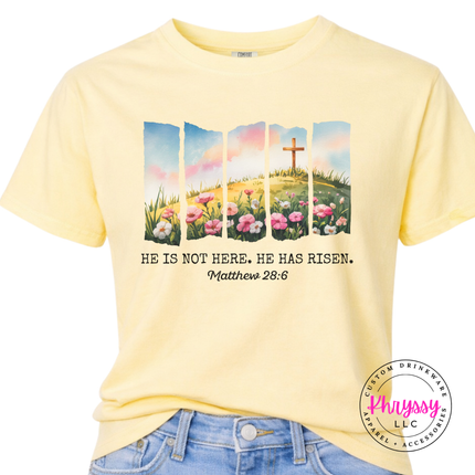Butter garment-dyed tee featuring a watercolor He Is Not Here He Has Risen design.