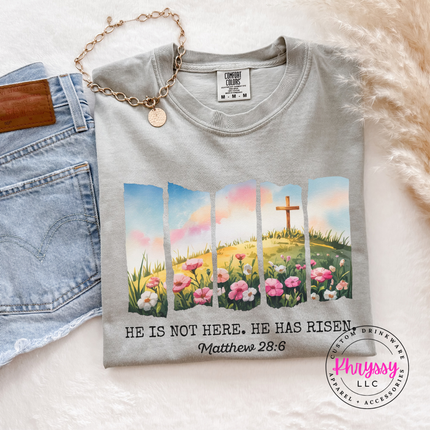 Granite garment-dyed tee showing a He Has Risen cross and flowers Easter print.