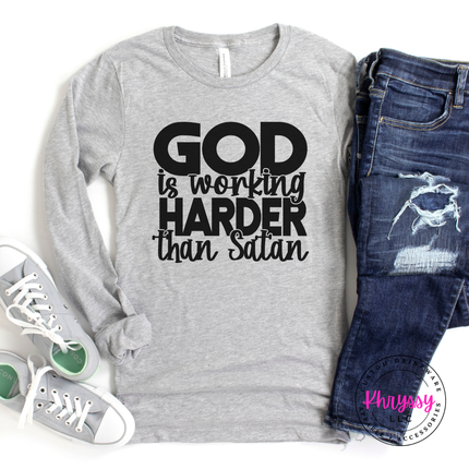 Athletic Heather long sleeve tee with bold black God Is Working lettering