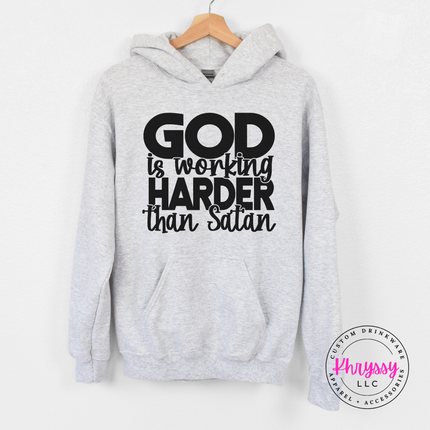 Ash Grey hoodie with bold black God Is Working Harder Than Satan lettering