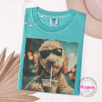 Teal t-shirt with a dog wearing sunglasses and drinking coffee design, branded 'Phrysy'.