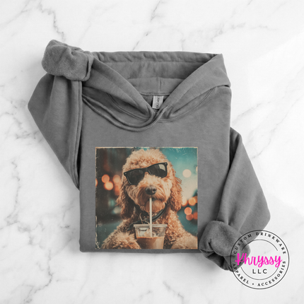 Gray hoodie with a dog wearing sunglasses and a drink graphic on a marble surface, branded 'Brtsy'.