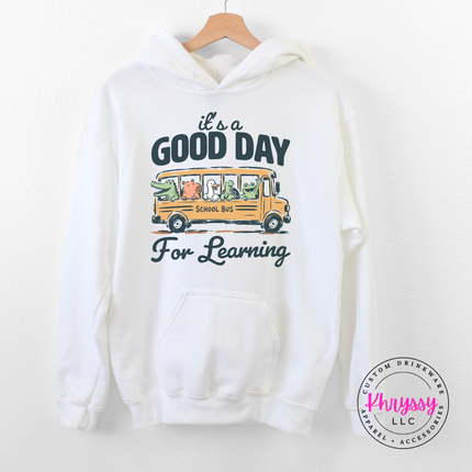 White hoodie with turtle, frog, and groundhog bus design.