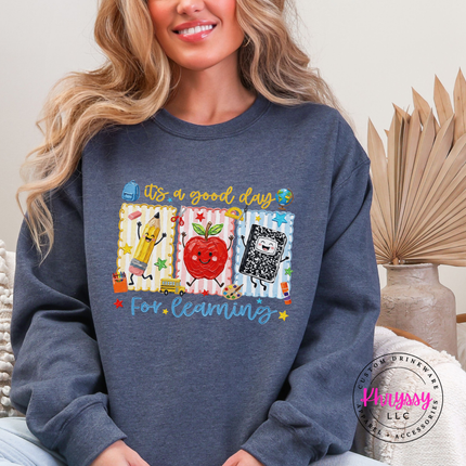 Heather Sport Dark Navy crewneck with cheerful classroom pencil and notebook art.