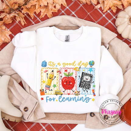 White sweatshirt with Good Day For Learning school graphic.