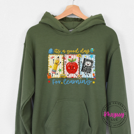 Military green colored cozy hoodie with Good Day For Learning school supply print.