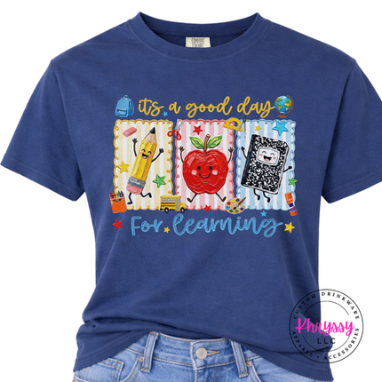 Navy pigment-dyed t-shirt with Good Day For Learning school supply graphics.