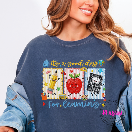 Denim tee with a cheerful classroom-themed pencil and apple print.