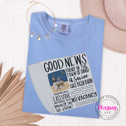 Chambray long sleeve tee showing a Good News newspaper with a nativity photo.