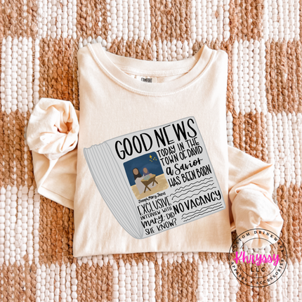 Model wearing the Good News nativity long sleeve tee in Ivory.