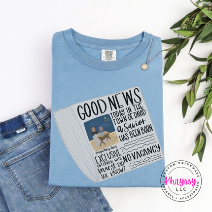 Washed Denim long sleeve tee showing a Good News newspaper with a nativity photo.