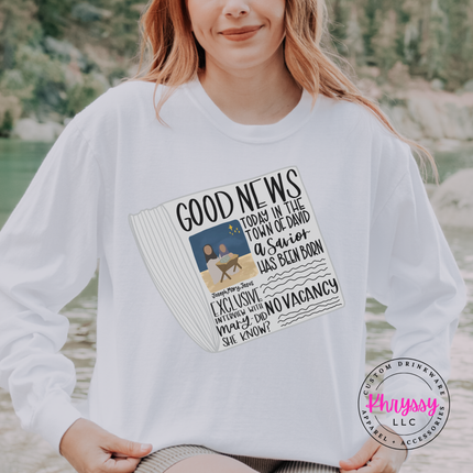 Flat lay of the Good News nativity Christmas long sleeve tee in White.