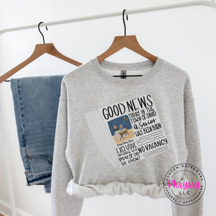 Ash crewneck sweatshirt featuring a vintage Good News nativity newspaper.