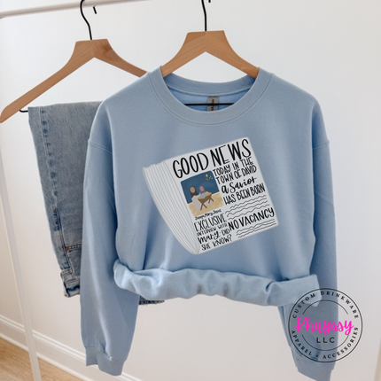 Light Blue crewneck sweatshirt featuring a vintage Good News nativity newspaper.
