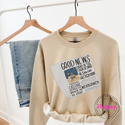 Close up of the Good News nativity art on a Sand crewneck sweatshirt.