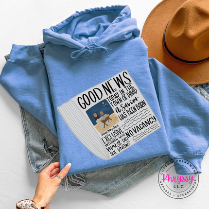 Model wearing the Good News nativity hoodie in Carolina Blue.