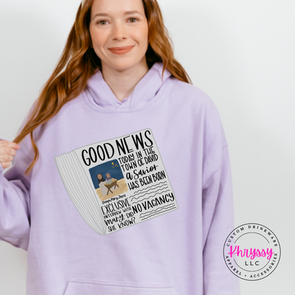Model wearing the Good News nativity hoodie in Orchid.