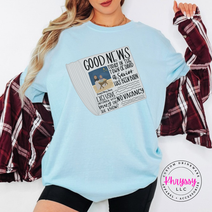 Chambray tee showing a Good News newspaper with a nativity photo.
