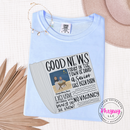 Ice Blue tee featuring a vintage Good News nativity newspaper.