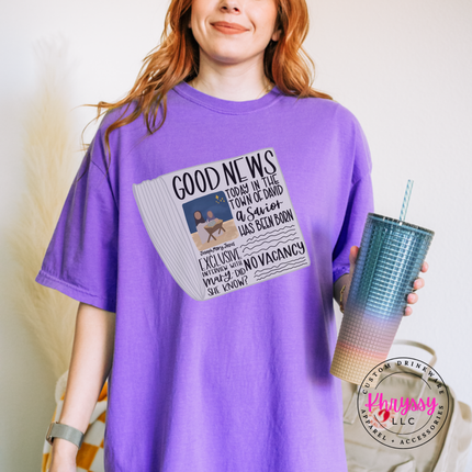Close up of the Good News nativity art on an Orchid tee.