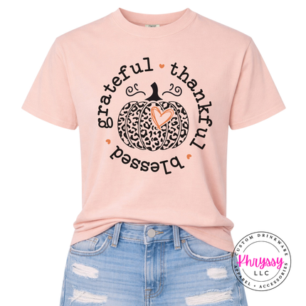 Peachy colored graphic tee featuring a grateful thankful blessed circle print.