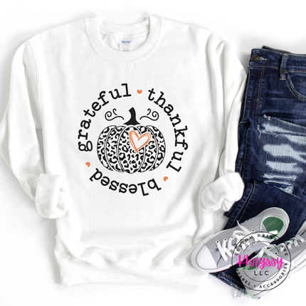 White crewneck sweatshirt with a leopard print pumpkin and heart design.