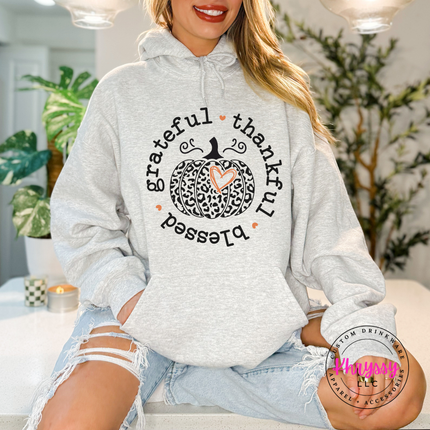 Ash pullover hoodie with a leopard print pumpkin and heart design.