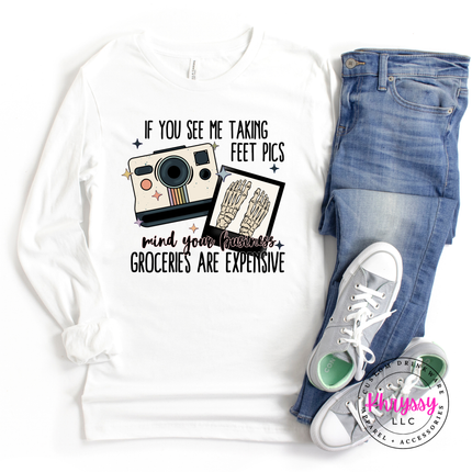 White sweatshirt with graphic design, jeans, and sneakers on a white background