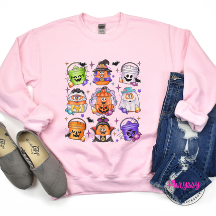 Light pink crewneck sweatshirt featuring a colorful trick-or-treat bucket collage.