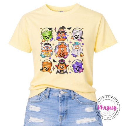 Butter graphic tee featuring nine colorful trick-or-treat bucket characters.