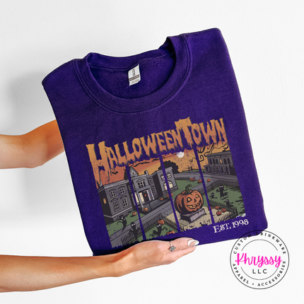 Purple crewneck sweatshirt with the spooky town square jack o lantern print