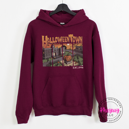 Maroon hoodie with the vintage Halloween town pumpkin scene graphic