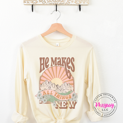 Natural long sleeve showing boho mountains and a vintage sunburst.
