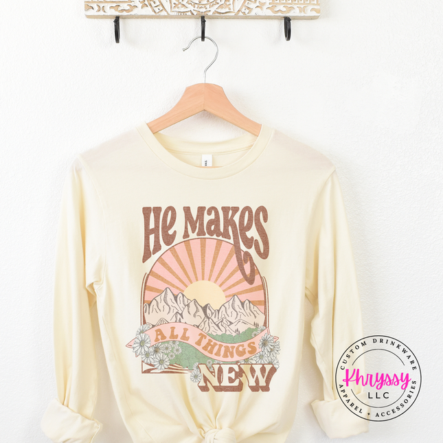 Natural long sleeve showing boho mountains and a vintage sunburst.