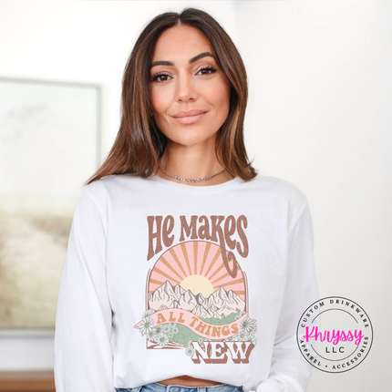 white long sleeve printed with a boho He Makes All Things New graphic.