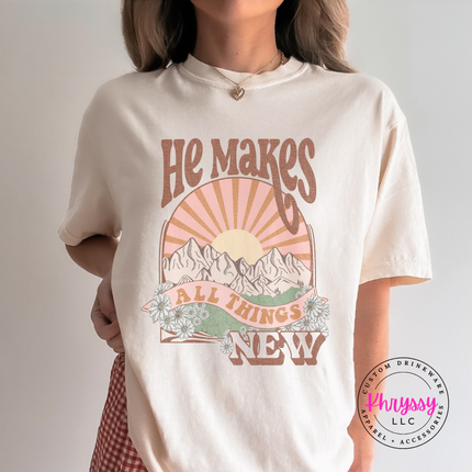 Ivory Comfort Colors tee showing boho mountains and a vintage sunburst.