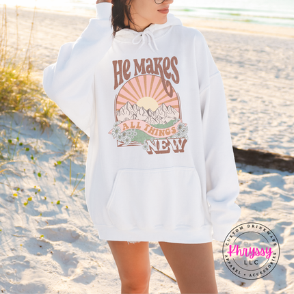 white hoodie showing boho mountains and a vintage sunburst.