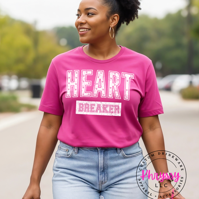 Woman wearing a pink 'HEART BREAKER' t-shirt outdoors