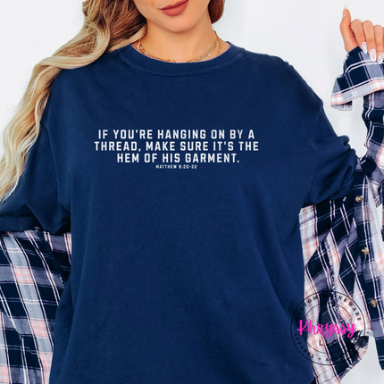True Navy tee featuring white hem of His garment Christian quote