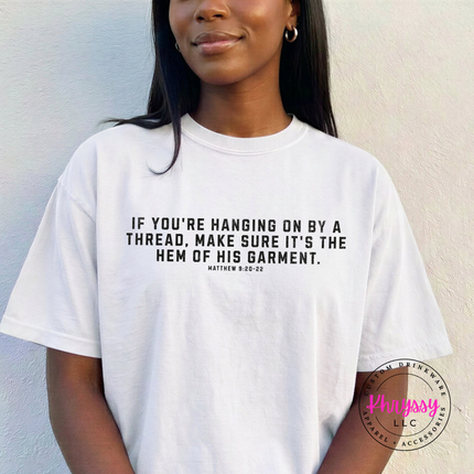White tee printed with the hanging on by a thread faith verse in black