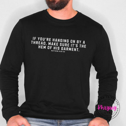 Black long sleeve tee featuring the hanging on by a thread verse in white