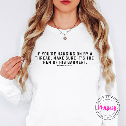 White long sleeve tee styled with jeans and the hem of His garment verse