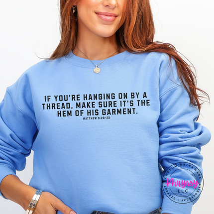 Carolina Blue crewneck sweatshirt with black hem of His garment scripture