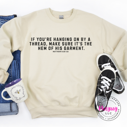 Folded Sand crewneck sweatshirt with black hem of His garment scripture