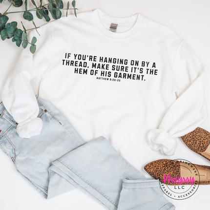 White crewneck sweatshirt featuring black hem of His garment faith quote
