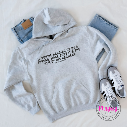 Ash hoodie printed with the hem of His garment scripture in black text