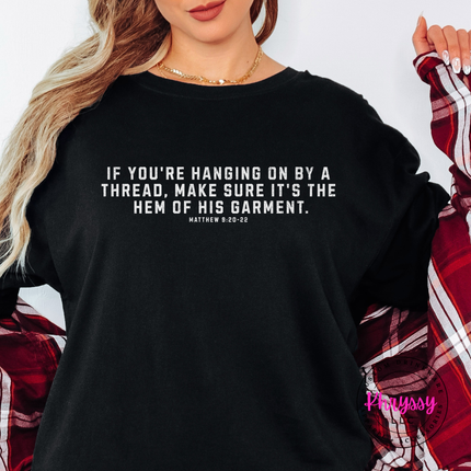Black tee with the hem of His garment scripture in white text